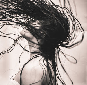 Close-up side view of woman with wet tousled hair