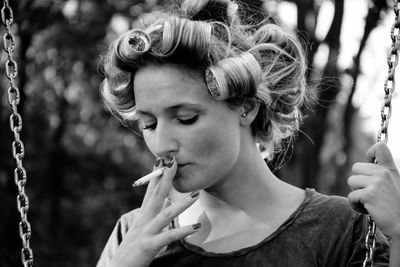 Portrait of young woman looking away outdoors