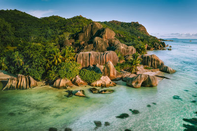 Panoramic shot of rocks in sea against sky