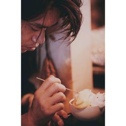 Close-up of man garnishing ice cream