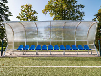 Row of house against trees on field