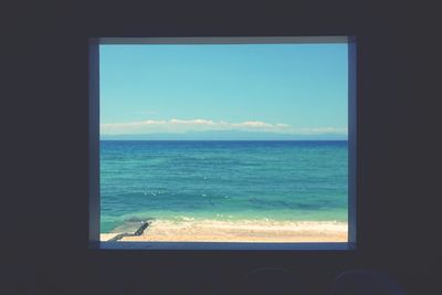 Scenic view of sea seen through window