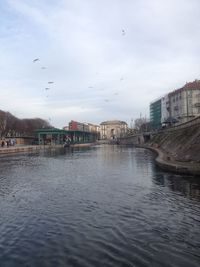 View of river by city against sky