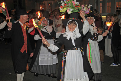 Group of people at music concert in city at night
