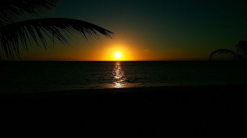 Scenic view of sea against clear sky at sunset