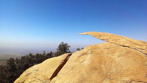 Scenic view of mountain against clear blue sky