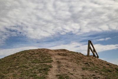 Low angle view of rocks on land against sky