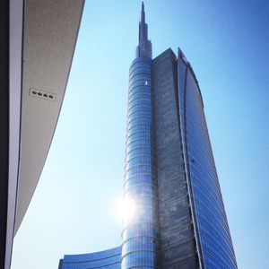 Low angle view of skyscrapers against blue sky