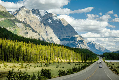 Scenic view of road with mountains against sky - icefield parkway, canada