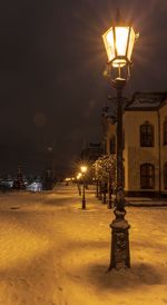 Illuminated street lights in city at night