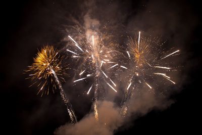 Low angle view of firework display at night