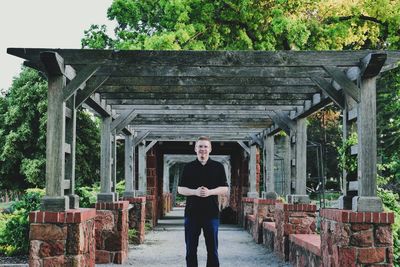 Man standing against built structure