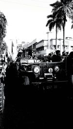 Cars on street in city against clear sky