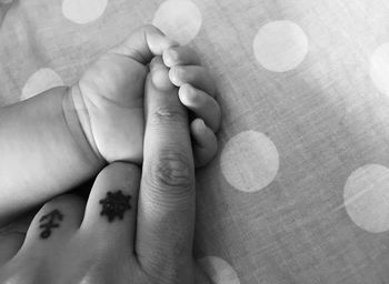 Close-up of baby holding hands