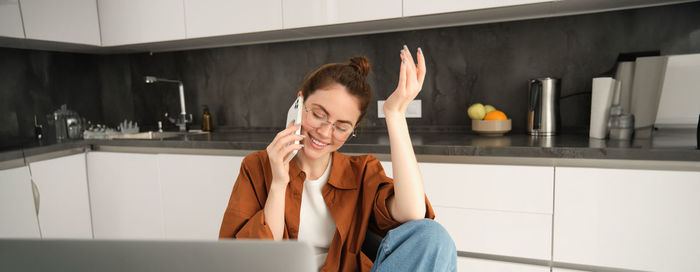 Side view of young woman using mobile phone in bathroom