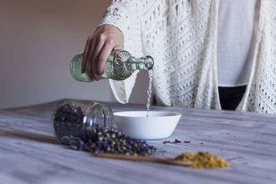 Midsection of person preparing food on table