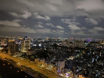 High angle view of illuminated cityscape against sky at night