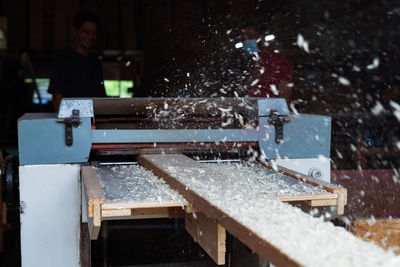 Defocused image of man working in factory