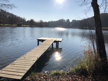 Pier on lake against sky