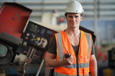 Rear view of man working in factory