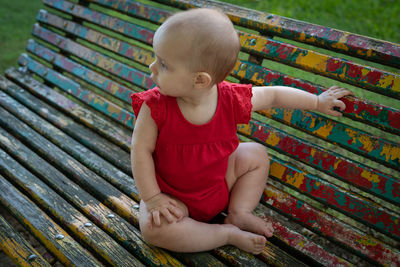 Full length of cute baby girl sitting outdoors