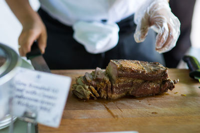 Close-up of person preparing food on table