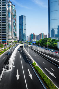 View of city street and buildings against sky