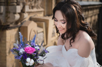 Stunning young bride with bouquet, portrait of smiling bride, happiness, wedding