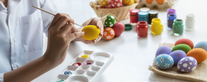 Midsection of multi colored candies on table