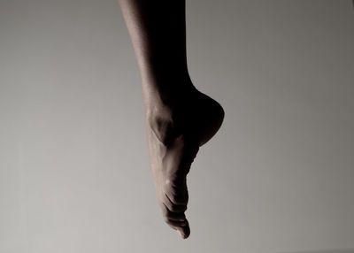 Low section of woman against white background