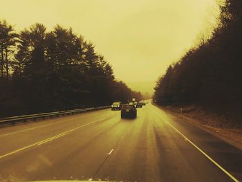 Cars on road against sky