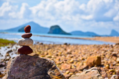 Close-up of rocks on shore against sky