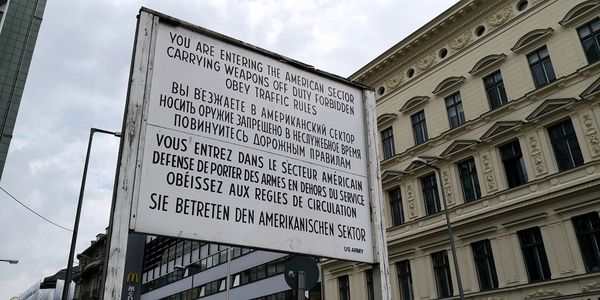 Low angle view of information sign against buildings in city