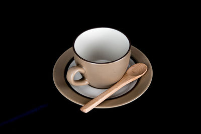 Close-up of coffee cup against black background