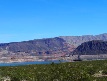 Scenic view of mountain against blue sky