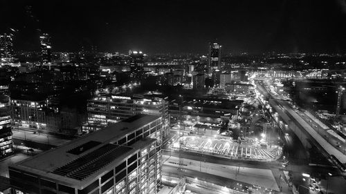 High angle view of illuminated cityscape against sky at night