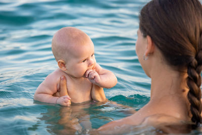 Mother and daughter in swimming pool