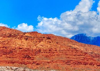 Scenic view of rocky mountains against blue sky