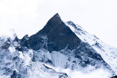 Scenic view of snowcapped mountains against clear sky