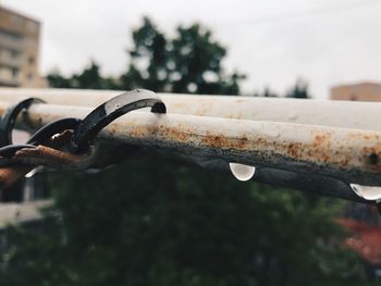 Close-up of rusty bicycle against sky