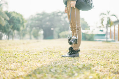 Low section of woman standing on grass