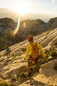 A father and son descending from lone peak, utah