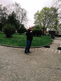 Full length of man photographing against sky