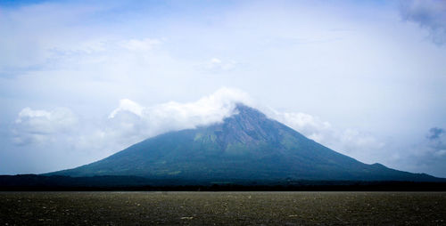 View of clouds over mountain peak