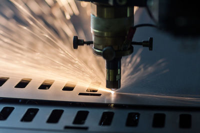 Close-up of illuminated machine in factory