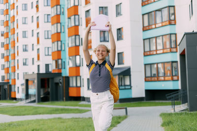 A happy student runs to school, hurries to classes, rejoices in the new academic year. 