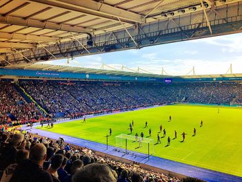 High angle view of people on soccer field against sky