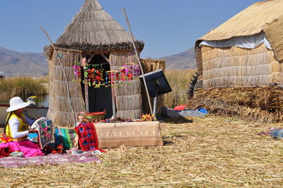 Traditional windmill on field against sky