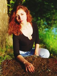 Beautiful young woman sitting outdoors