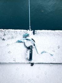 Snow covered boat over lake during winter